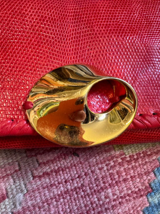 Jasmir, handmade red lizard skin clutch with a sculptural 70s clasp