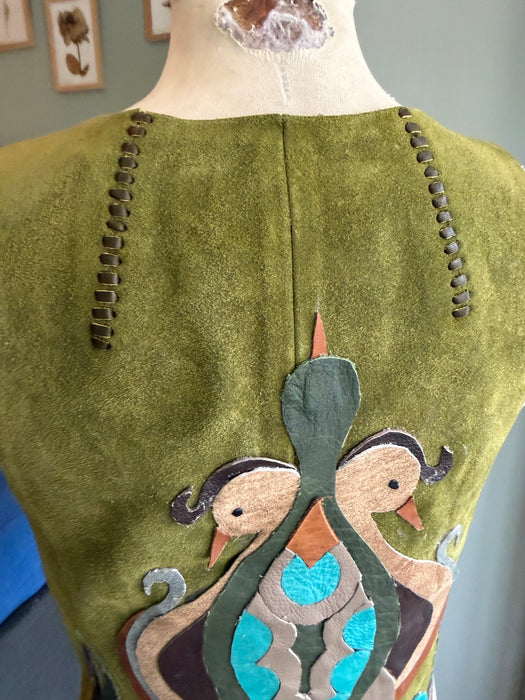 Basil, 70s olive green suede waistcoat with leather ties and handmade folk leather appliqué