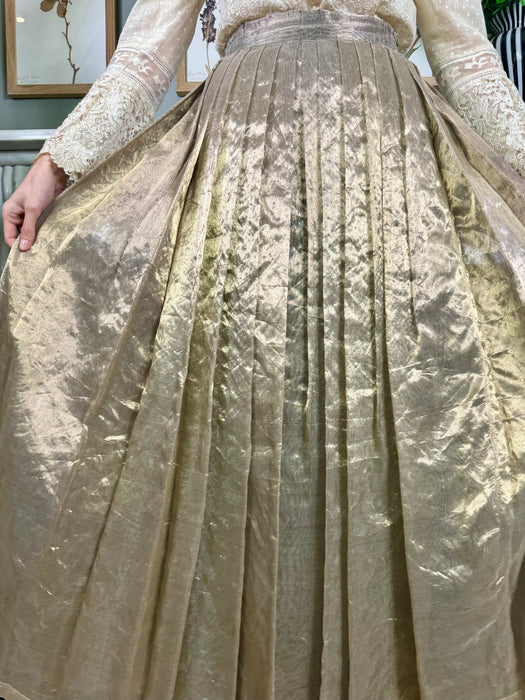 Katherine Cusack, gold lamé pleated skirt